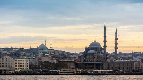 Yeni cami mosque against sky during sunset in city