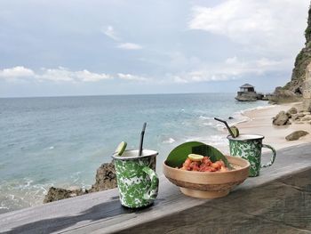 Panoramic shot of food on table by sea against sky