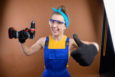 Portrait of young woman holding camera
