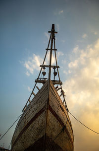 Low angle view of silhouette cranes against sky