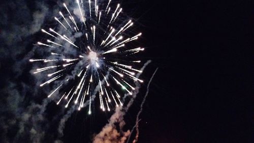 Low angle view of firework display at night