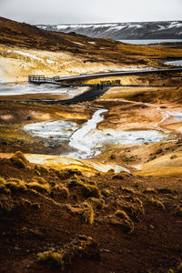 Scenic view of icelandic lava field against sky during winter