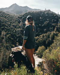 Woman on rock looking at mountains