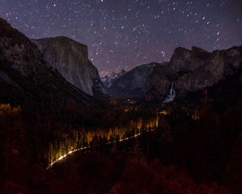 Scenic view of mountains against sky at night