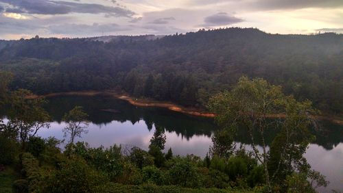 Scenic view of lake against cloudy sky