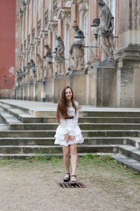 Full length portrait of a serious young woman