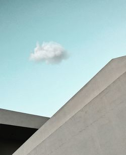 Low angle view of factory against blue sky