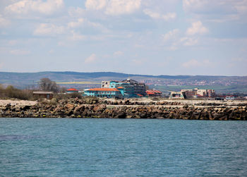 Scenic view of sea and buildings against sky