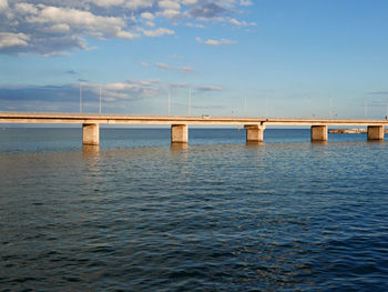 Bridge over sea against sky