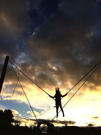 Silhouette man against sky during sunset