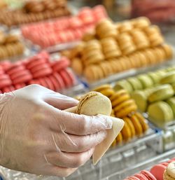 Midsection of person holding fruits at market stall