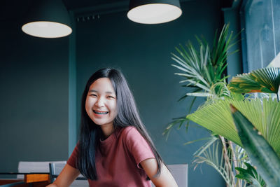 Portrait of smiling teenage girl at table