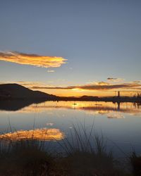 Scenic view of lake against sky during sunset