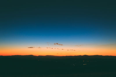 Scenic view of silhouette landscape against sky at sunset