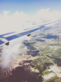 Cropped image of airplane flying over clouds