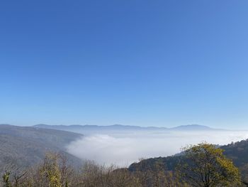 Scenic view of mountains against clear blue sky