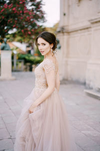 Young woman standing on footpath