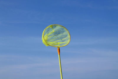 Low angle view of umbrella against blue sky