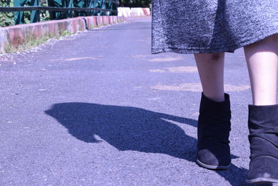 Low section of women standing on street