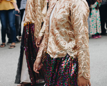 Low section of people standing on street