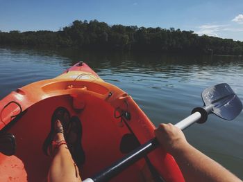 Close-up of hand on boat sailing in lake