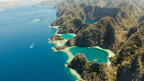 Tourist boats around the beautiful big and small lagoons, aerial view. palawan, philippines