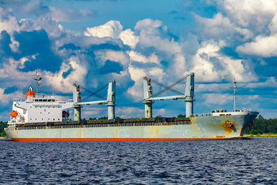 Commercial dock by sea against sky