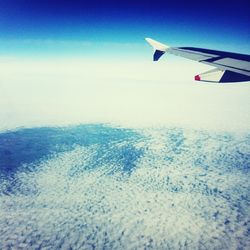 Cropped image of airplane flying over landscape