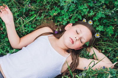 High angle view of cute girl lying down on field