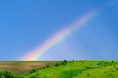 Very beautiful gentle spring photo. rainbow on field after rain. beautiful rainbow wallpaper. 