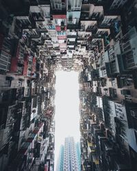 Low angle view of illuminated buildings in city against sky