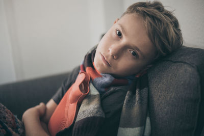 Portrait of boy sitting at home