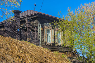 Exterior of abandoned building against clear blue sky