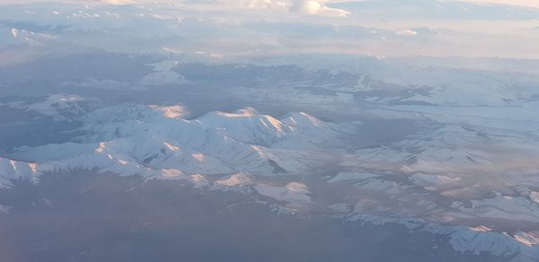 High angle view of snowcapped mountains against sky