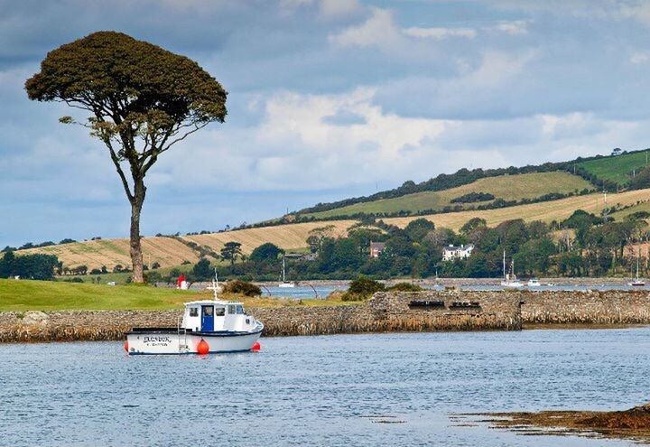 water, sky, transportation, nautical vessel, boat, tree, mode of transport, tranquil scene, waterfront, tranquility, cloud - sky, mountain, scenics, cloud, lake, nature, beauty in nature, river, cloudy, day