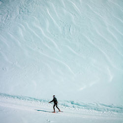 High angle view of man skiing on snow covered land