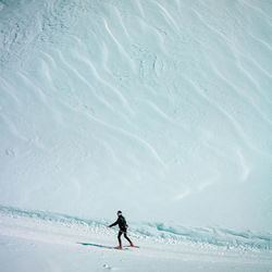 Man skiing on snow covered land