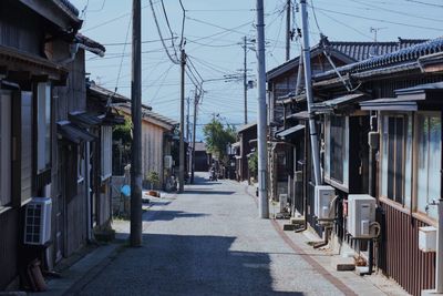 Street amidst buildings in city against sky