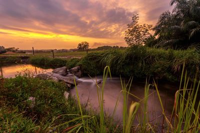 Scenic view of lake against sky during sunset