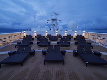 Empty chairs against blue sky at dusk