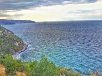 Scenic view of calm sea against cloudy sky