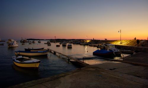 Boats in marina at sunset