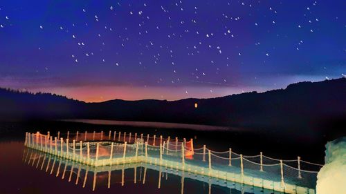 Scenic view of mountains against sky at night