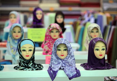 Busts wearing various patterned hijabs for sale at shop