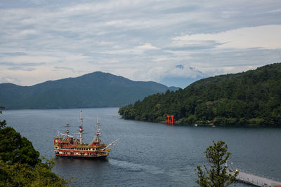 Scenic view of river and mountains against sky