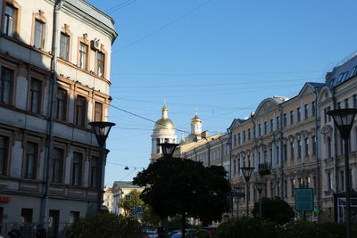 Buildings in city against clear sky