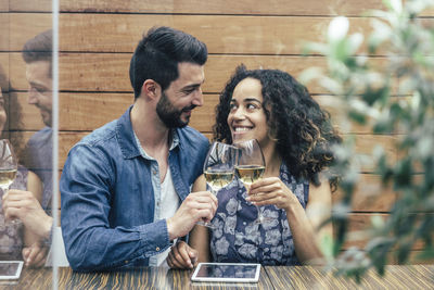 Young couple kissing in drinking glass