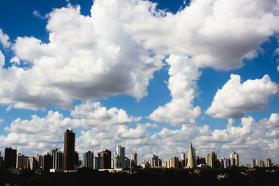 Buildings in city against cloudy sky