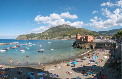 Group of people on beach, levanto, liguria, italy