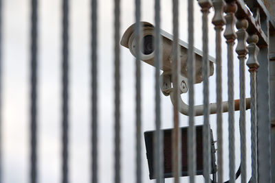 Ip cctv security camera and iron fence on grey sky background, cityscape. protected area, industrial